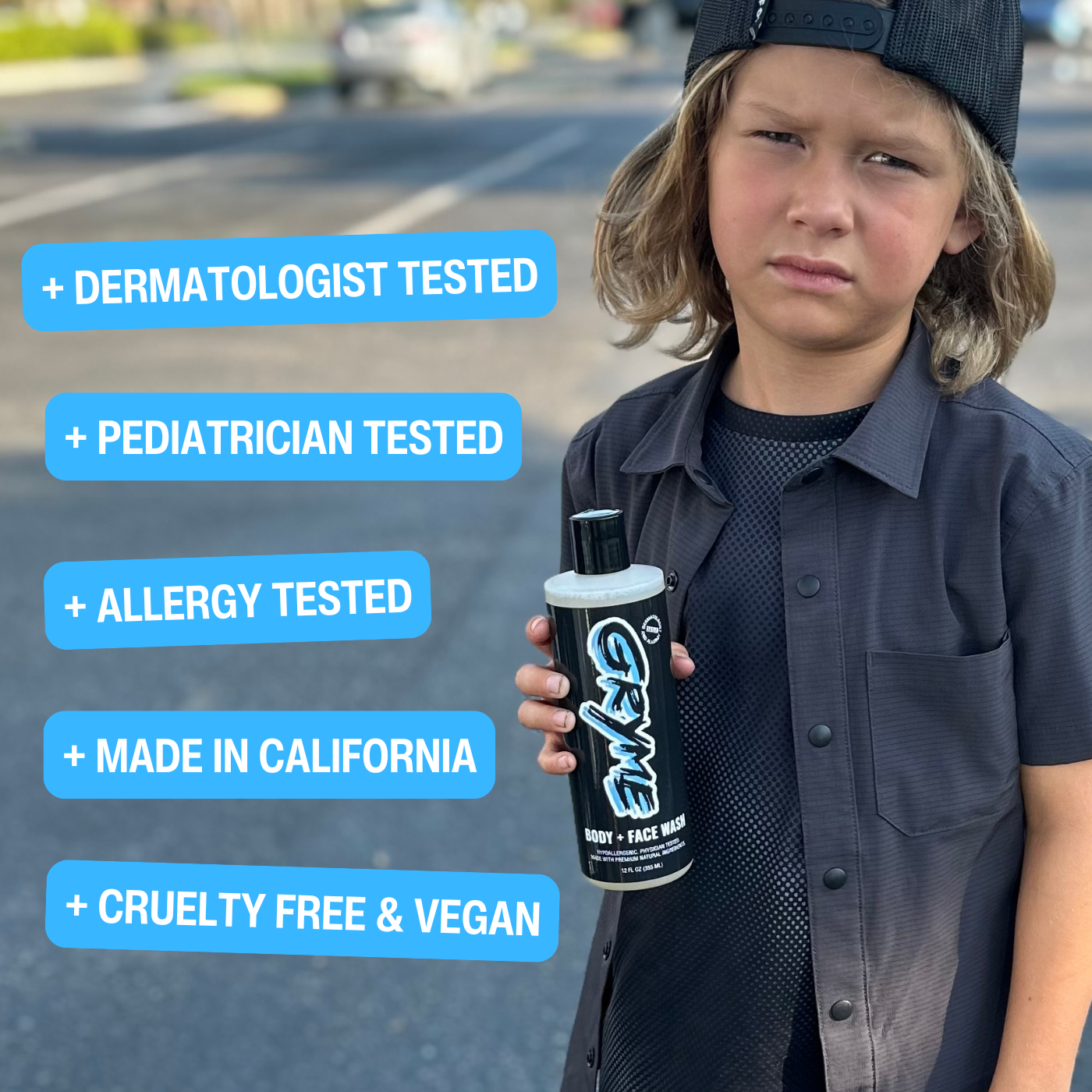 Six year old boy holding bottle of dermatologist tested Gryme Body and Face Wash